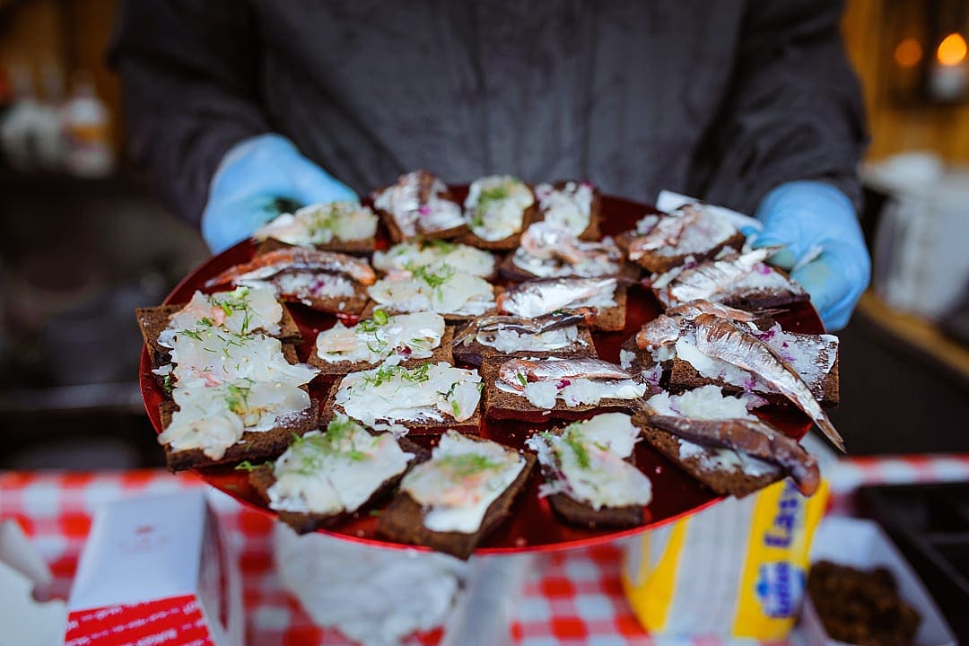 Plate of traditional rye bread with herring at the Baltic Herring Festival in Helsinki, Finland