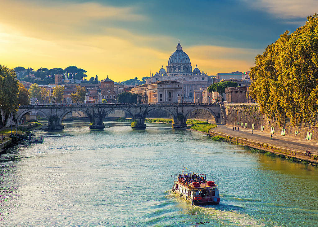 Boat sailing on Tiber River with Saint Peter's Basilica in Rome, Italy