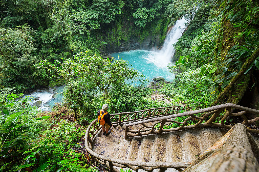 Man hiking to waterfall in Costa Rica