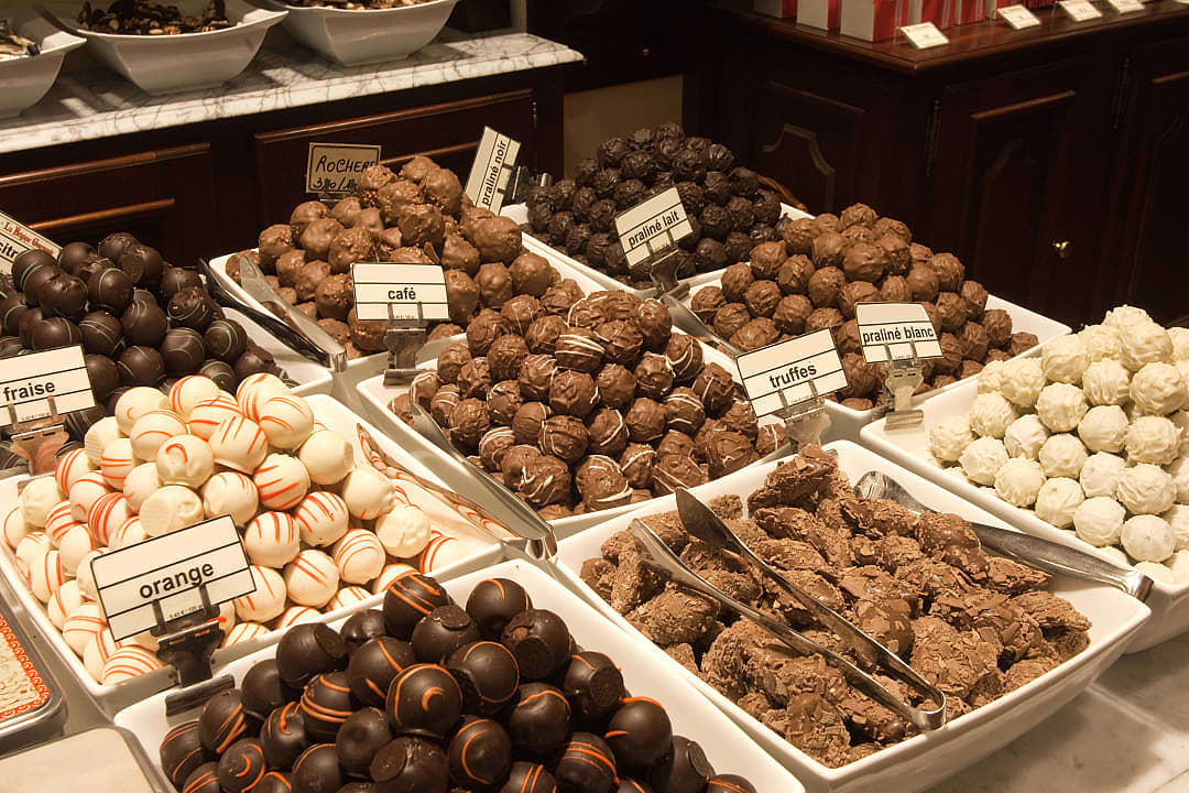 A selection of Belgian chocolate pralines sold in a store.