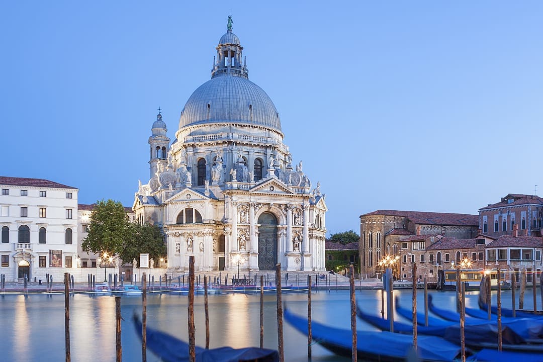 Famous Basilica di Santa Maria della Salute and gondolas in Venice, Italy