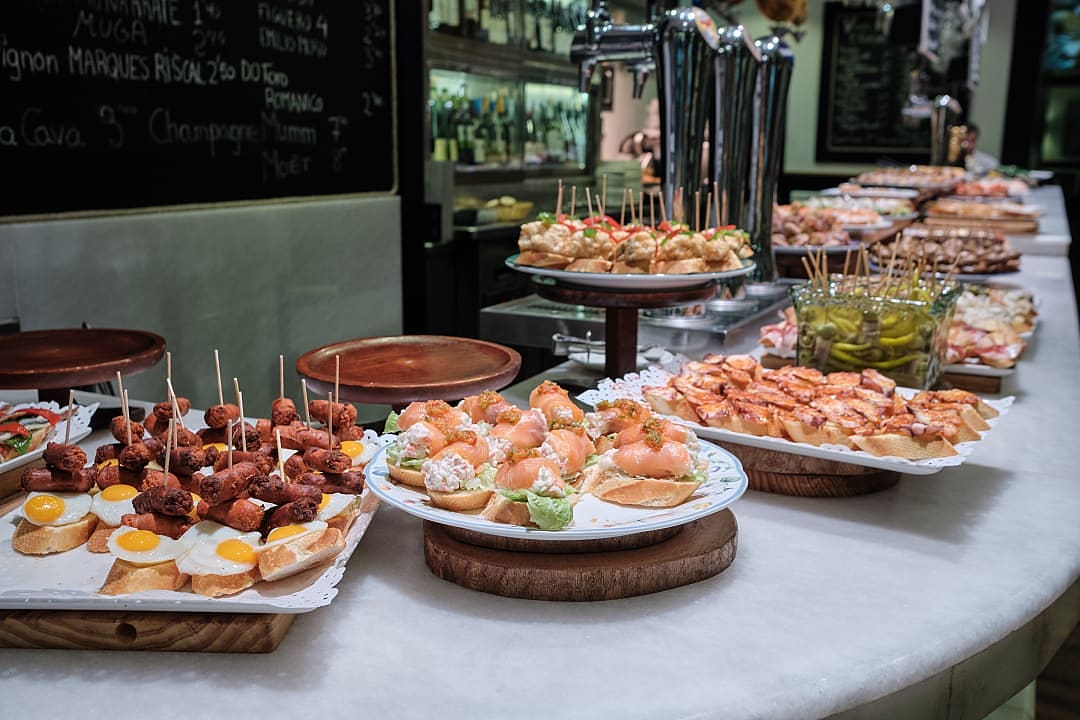 Delicious Basque pintxos displayed at a bar in San Sebastián, Spain, featuring seafood and tapas