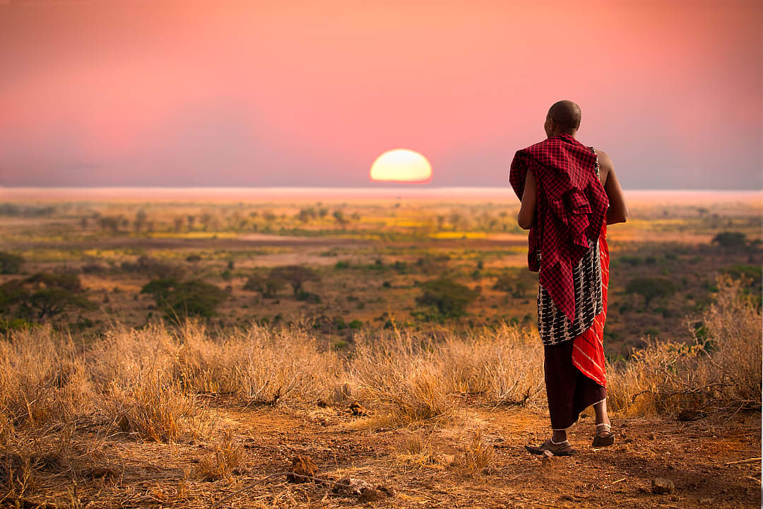 A Maasai warrior watches as the sun sets.