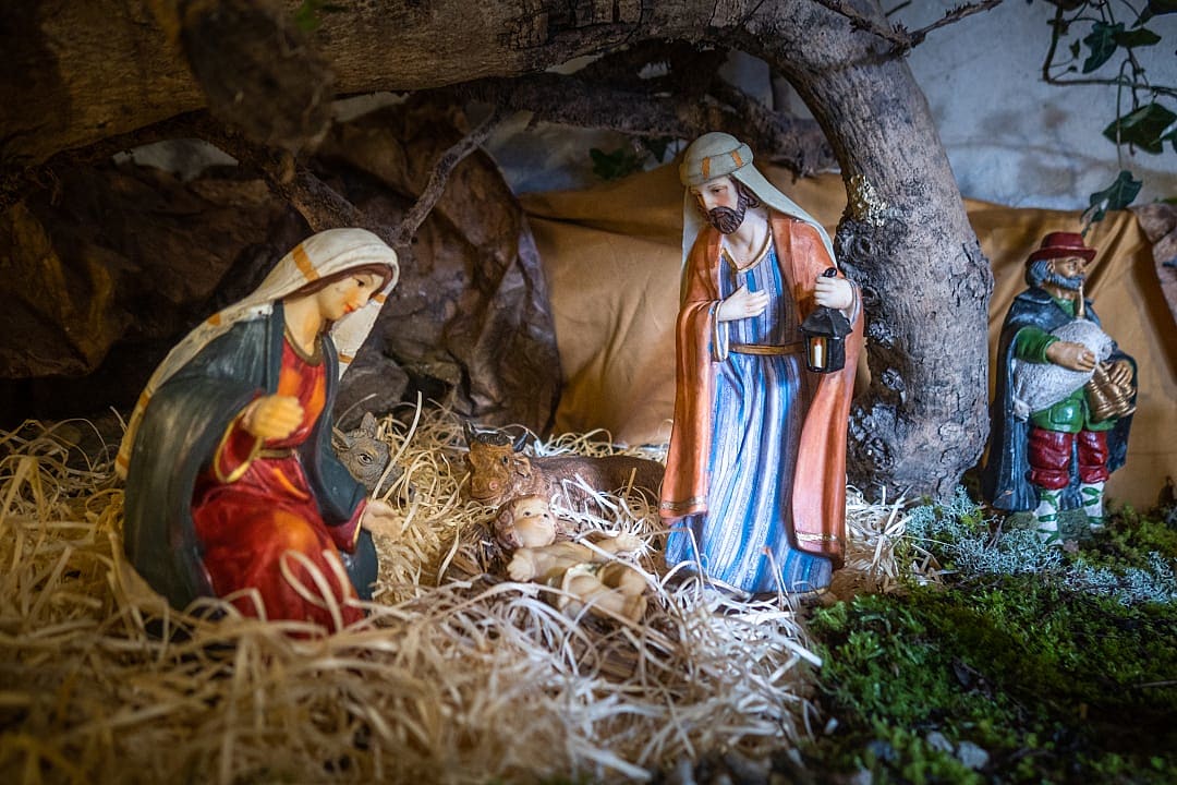 Handcrafted nativity scene with Mary, Joseph, and Baby Jesus in a Tuscan Christmas display in Italy