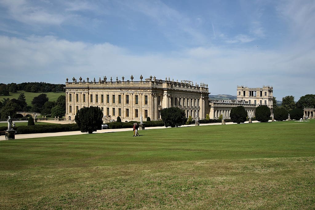 Couple walking on the lawns at Chatsworth House in Derbyshire, England