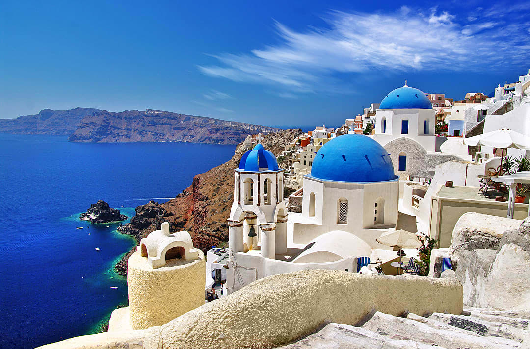 Santorini blue domes with caldera and ocean