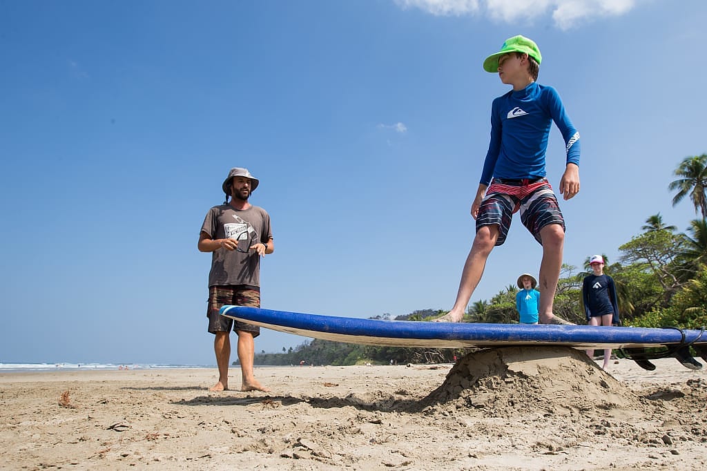 Kids getting surfing lessons in Costa Rica