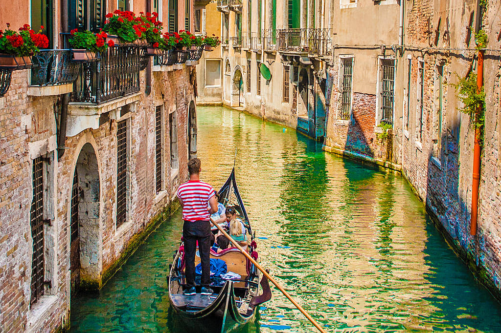 Traditional gondola ride through the canals in Venice, Italy