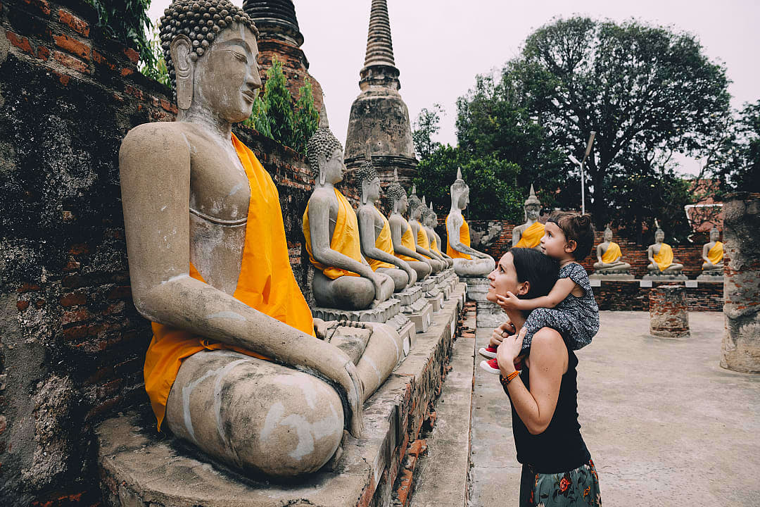 Mother and child admiring Buddha statues at Wat Yai Chai Mongkhon in Ayutthaya, Thailand