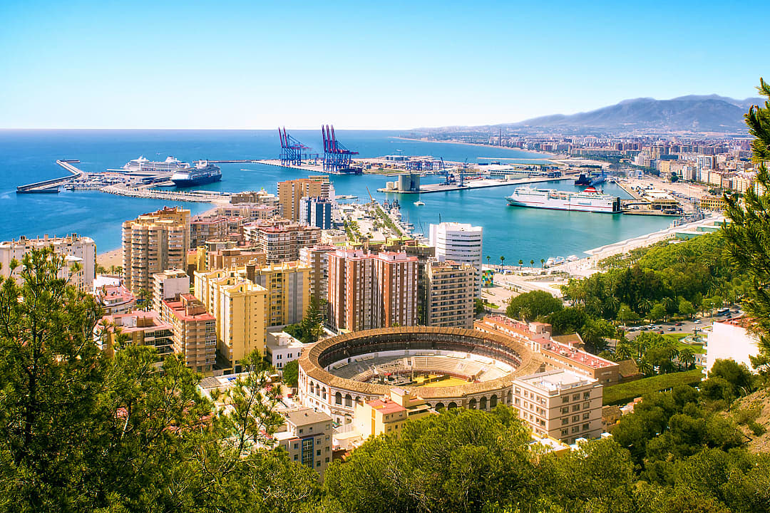 View of Malaga Bullring and Harbor in Spain.