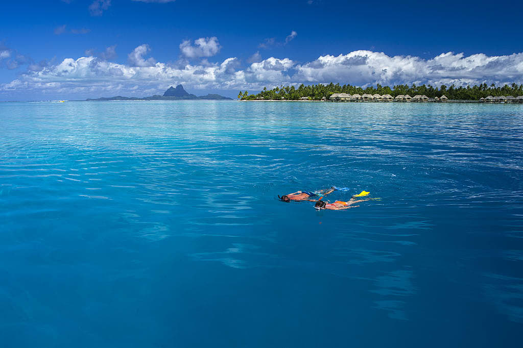 Couple snorkeling in Tahaa, Tahiti. Photo by David Kirkland, courtesy of Tahiti Tourisme