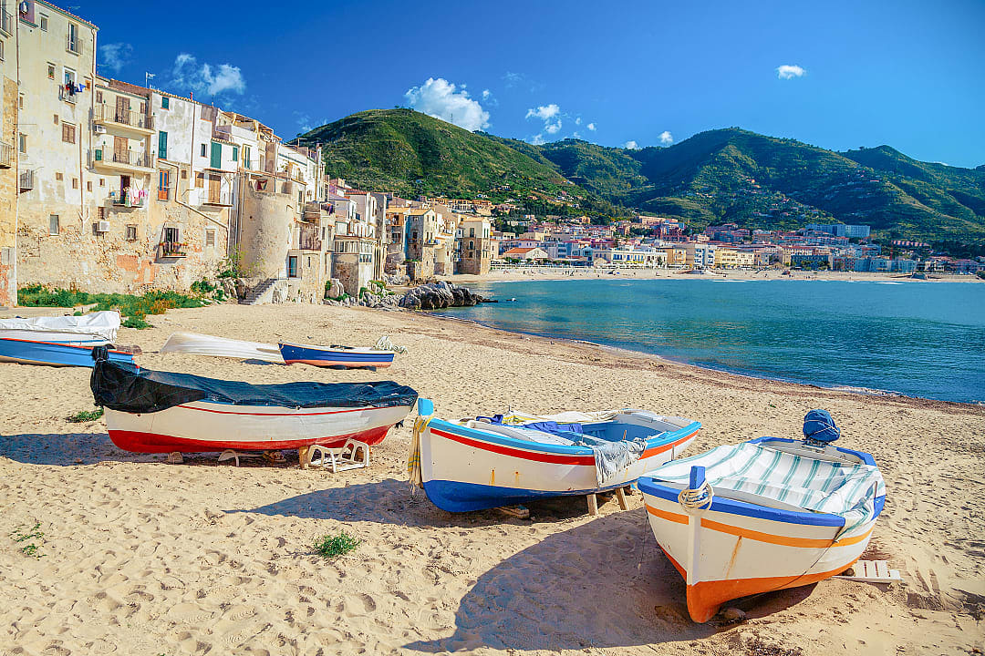 Colorful wooden fishing boats on the beach in old wooden fishing boats on the beach of Cefalu