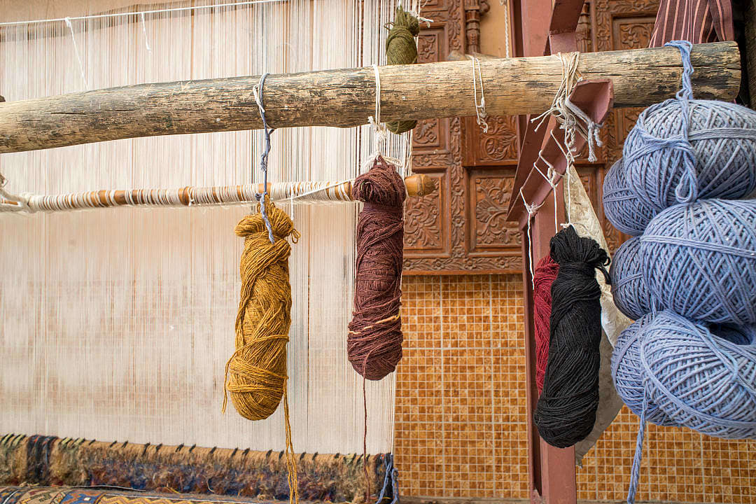 Bundle of naturally dyed yarn on a wooden loom in India