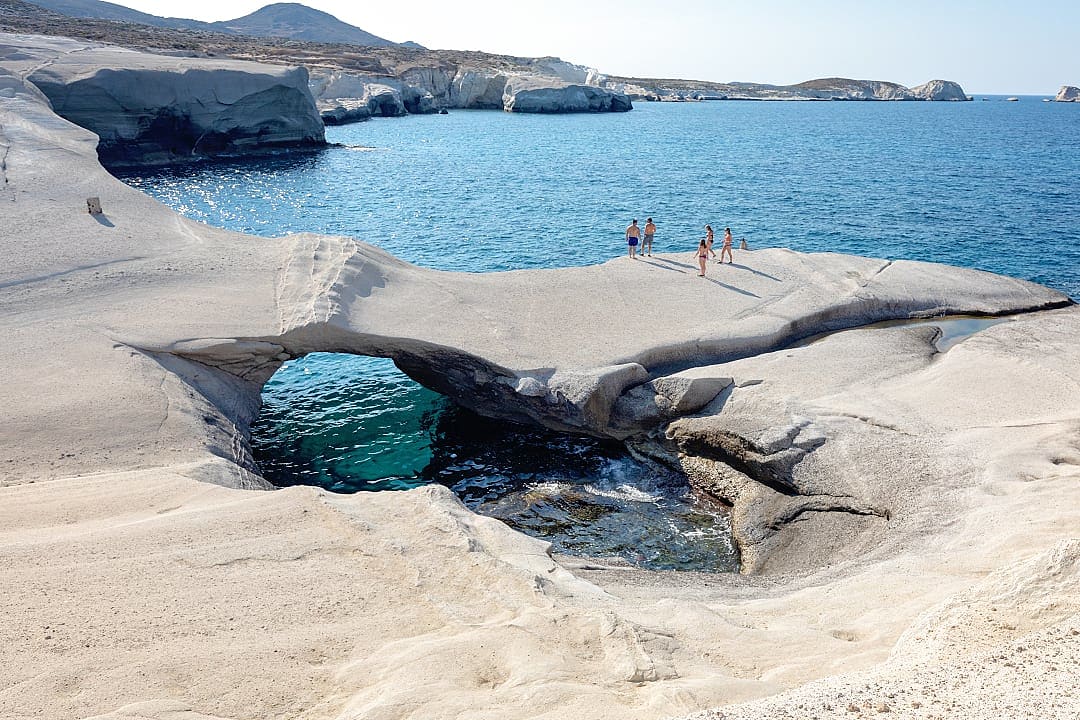 White volcanic cliffs of Milos contrast beautifully with the deep blue sea.