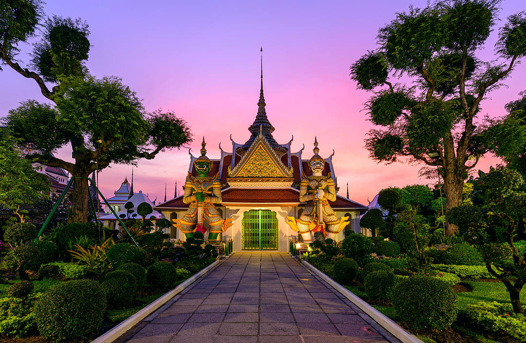 Giant statues and pagoda at Wat Arun in Bangkok Thailand.