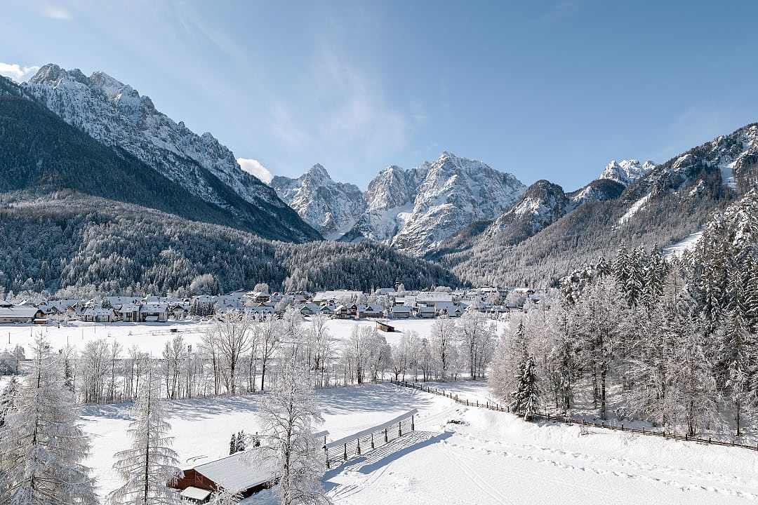 Snowy alpine valley village surrounded by mountains