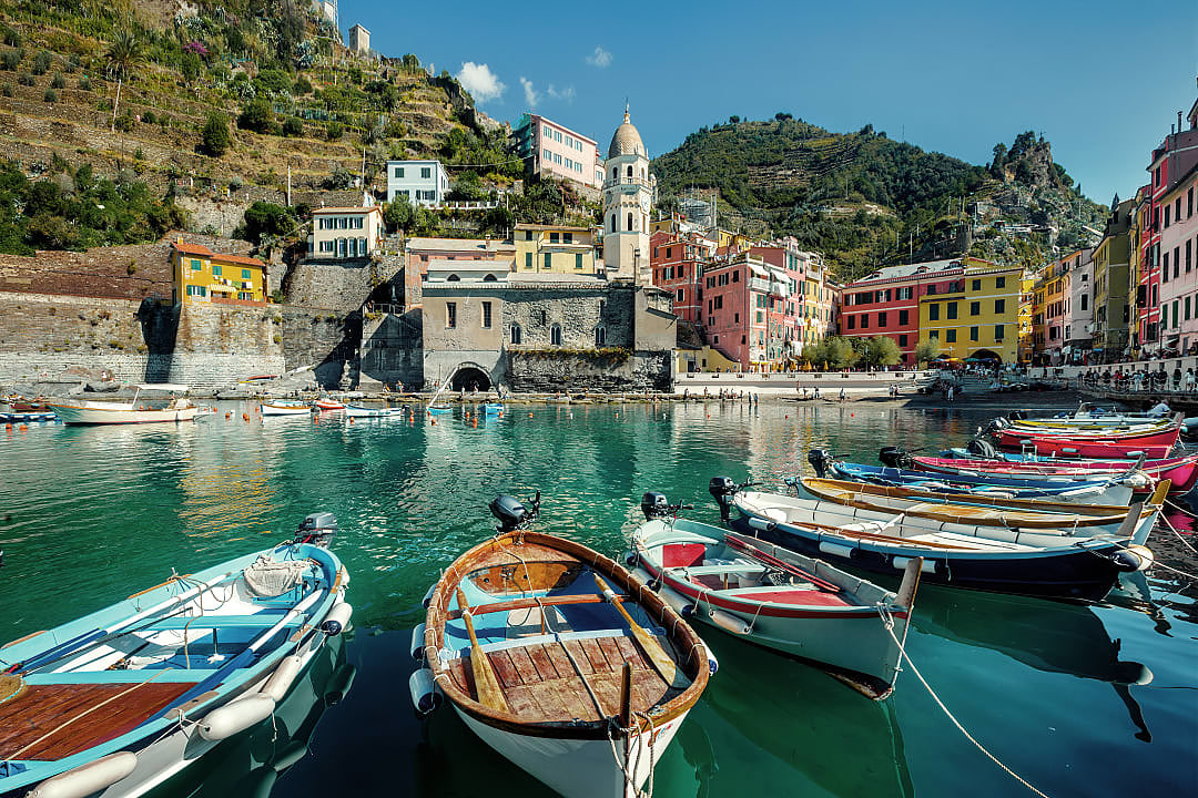 Colorful fishing boats in the harbor of Vernazza, a picturesque village in Cinque Terre, Italy