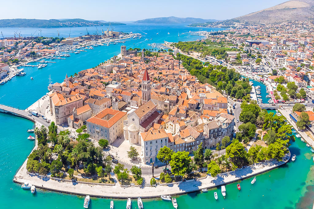 Birds eye perspective on historic Trogir, Croatia,  in summer with turquoise bay waters and mountains