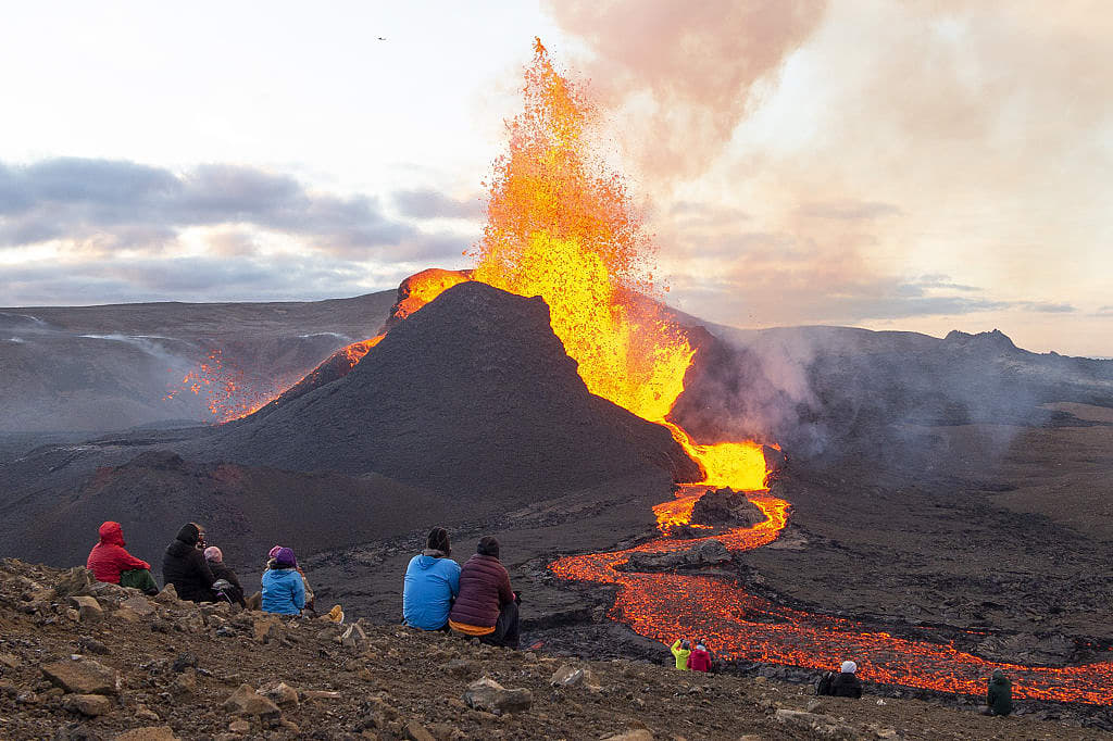 Couples watching fagradalsfjall volcano erupt in Icelaand