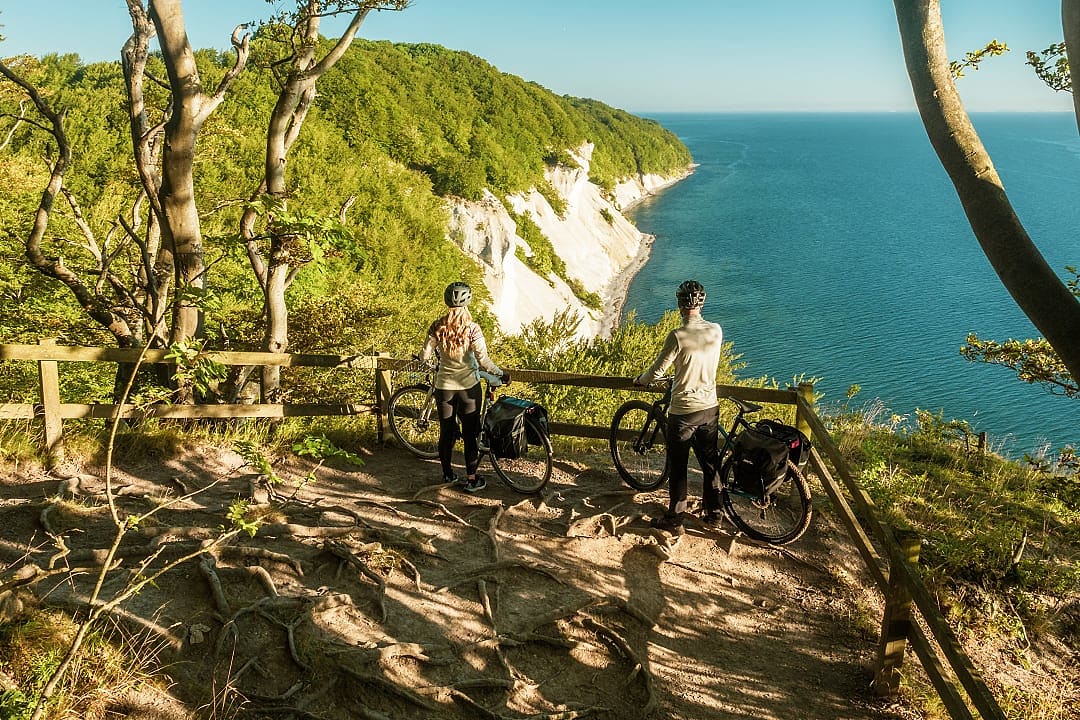 Couple with bikes at an overlook of the Chalk cliffs in Møns Klint, Denmark