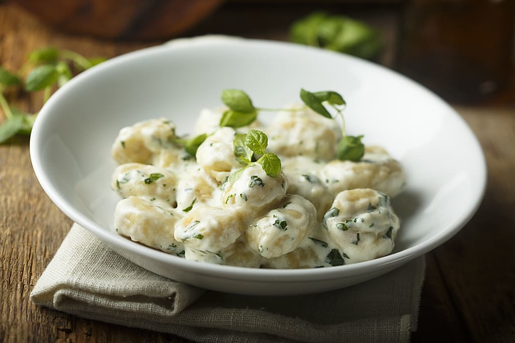 Potato gnocchi with creamy basil sauce