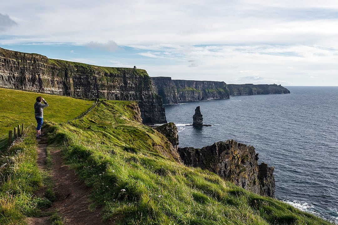 Senior woman hiking the Cliffs of Moher in Ireland