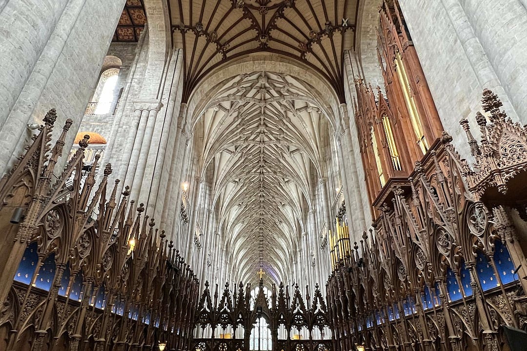 Gothic fan-vaulted ceiling and ornate choir stalls inside Winchester Cathedral, England