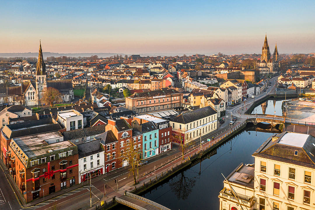 Aerial view of colorful buildings and churches along the River Lee in Cork, Ireland