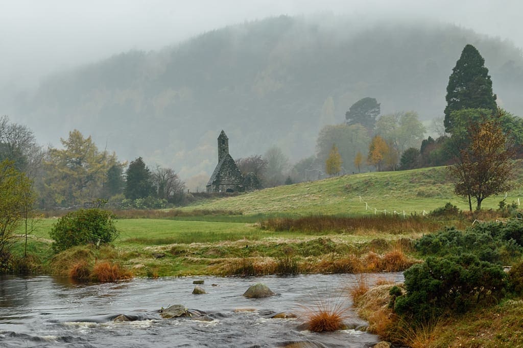 Ruins of an ancient monastery in the morning fog, Glendalough, County Wicklow, Ireland