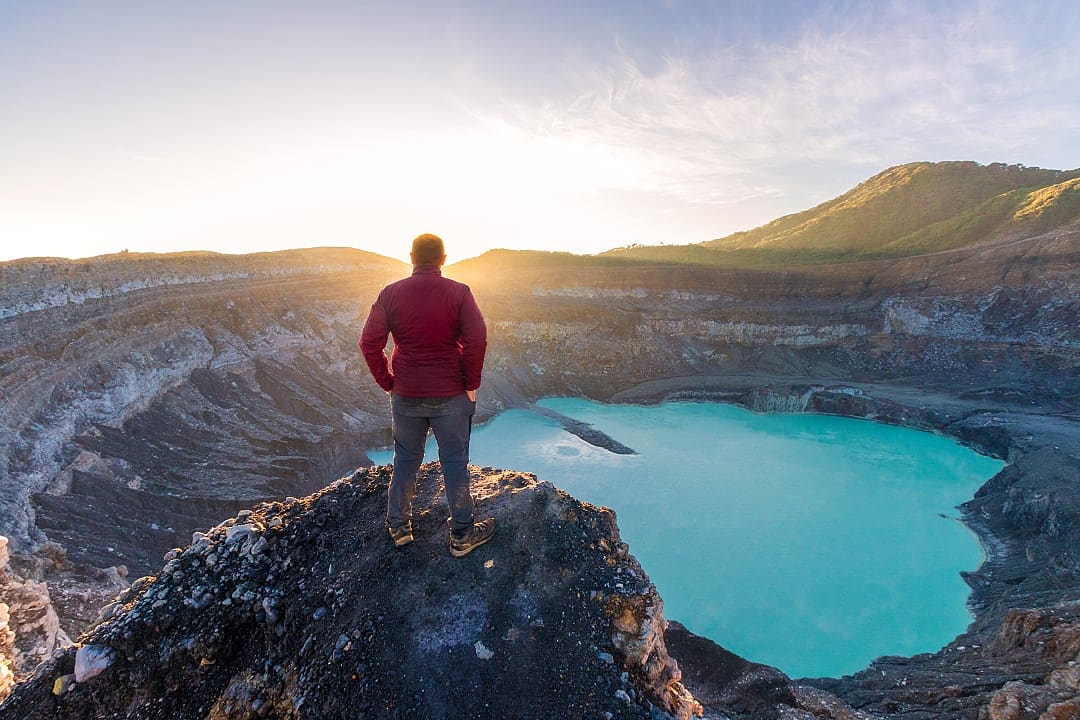 Hiker at Poas Volcano Crater Lagoon in Costa Rica