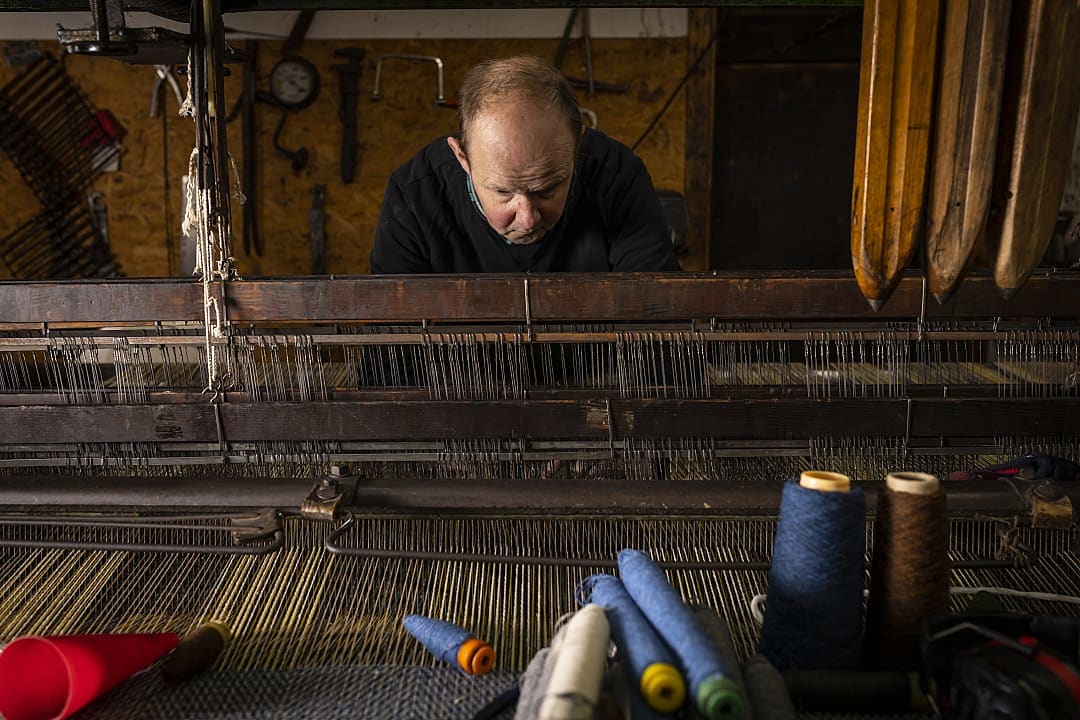 Artisan working on a tartan at Islay Woollen Mill in Scotland
