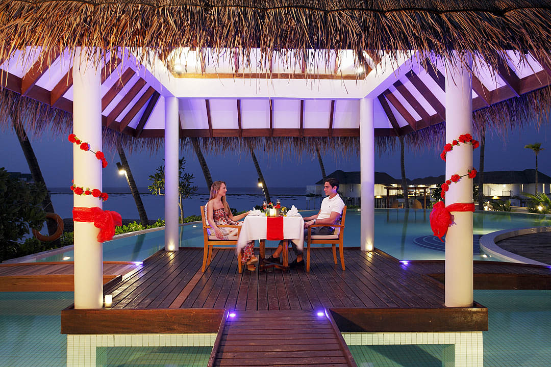 Couple enjoying a luxury dinner at Machchafushi, photo courtesy of Centara Hotels & Resorts.