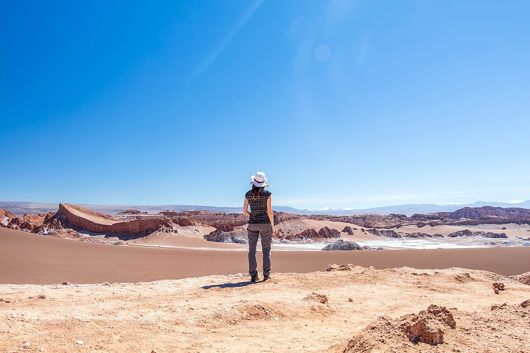 Woman admiring stunning landscape of Moon Valley in Atacama Desert, Chile