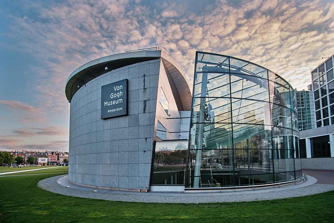 The modern glass and stone exterior of the Van Gogh Museum in Amsterdam.