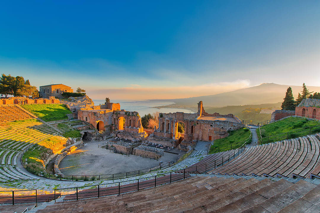 Ancient theatre of Taormina in Sicily with Mount Etna in the background