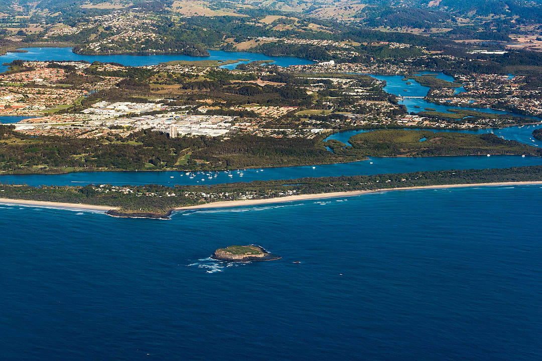 Aerial view of coastal town with beaches, rivers, and forest in New South Wales, Australia