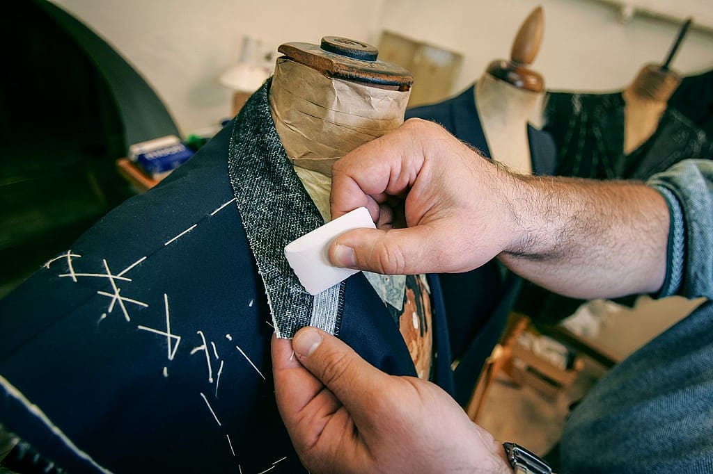Tailor making a custom suit jacket