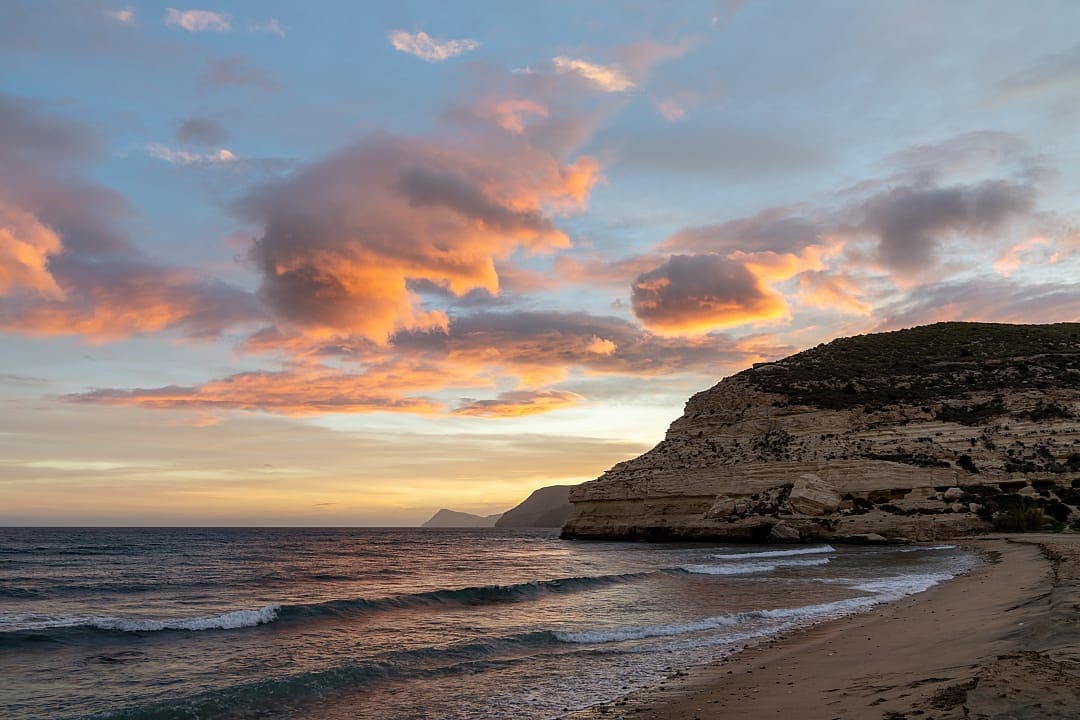 Beautiful ocean sunset on the Costa del Sol in Spain with beach and cliffs