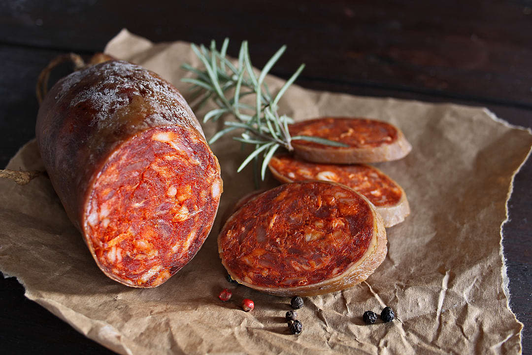 a traditional Croatian cured sausage made from pork, seasoned with paprika, garlic, and chili, then slow-fermented and smoked.