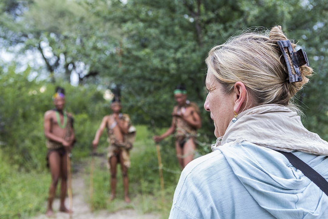 Woman meeting members of the San People Tribe in Boswana