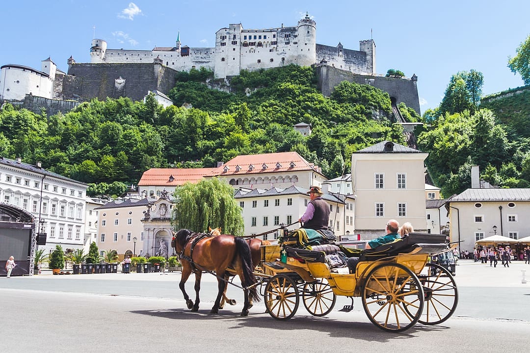 Tourists sightseeing in horse carriage in Salzburg, Austria