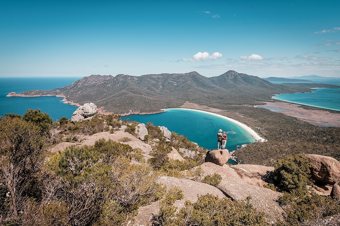 Couple enjoying the view from mount amos to the spectacular wineglass bay