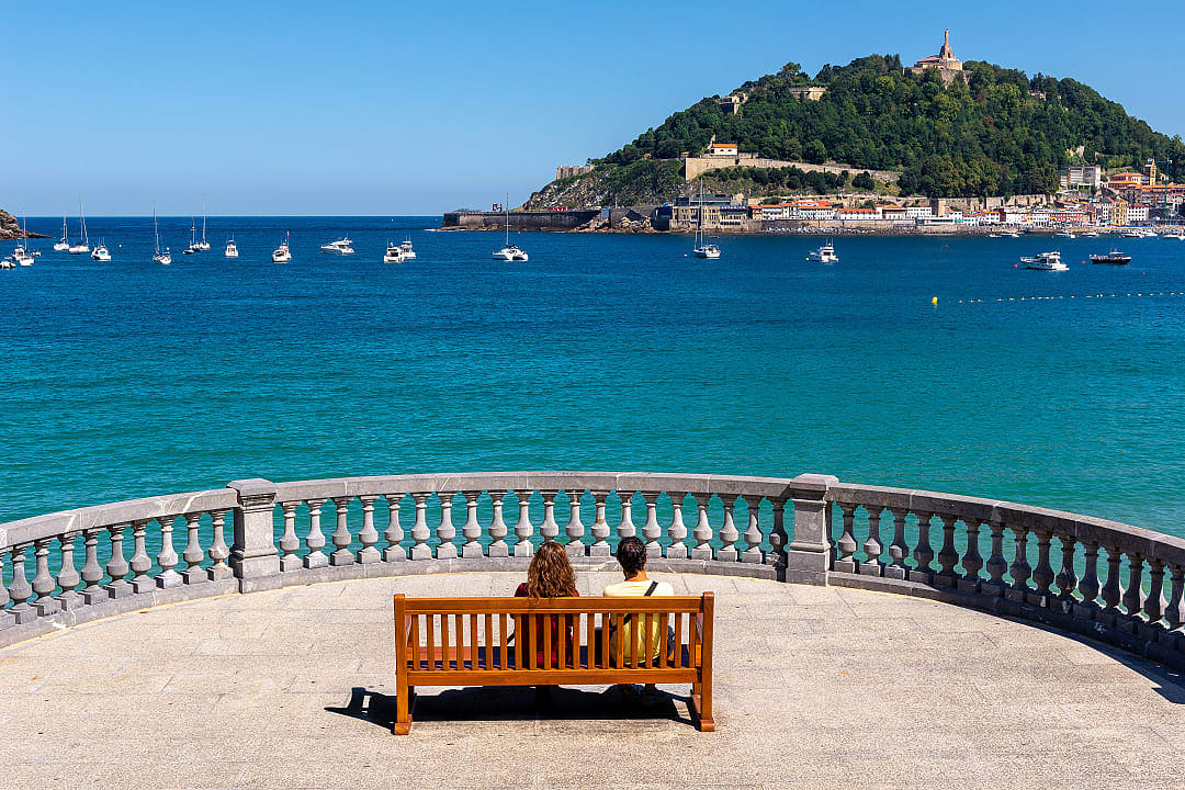 A couple enjoys a view from the La Concha Promenade in San Sebastián