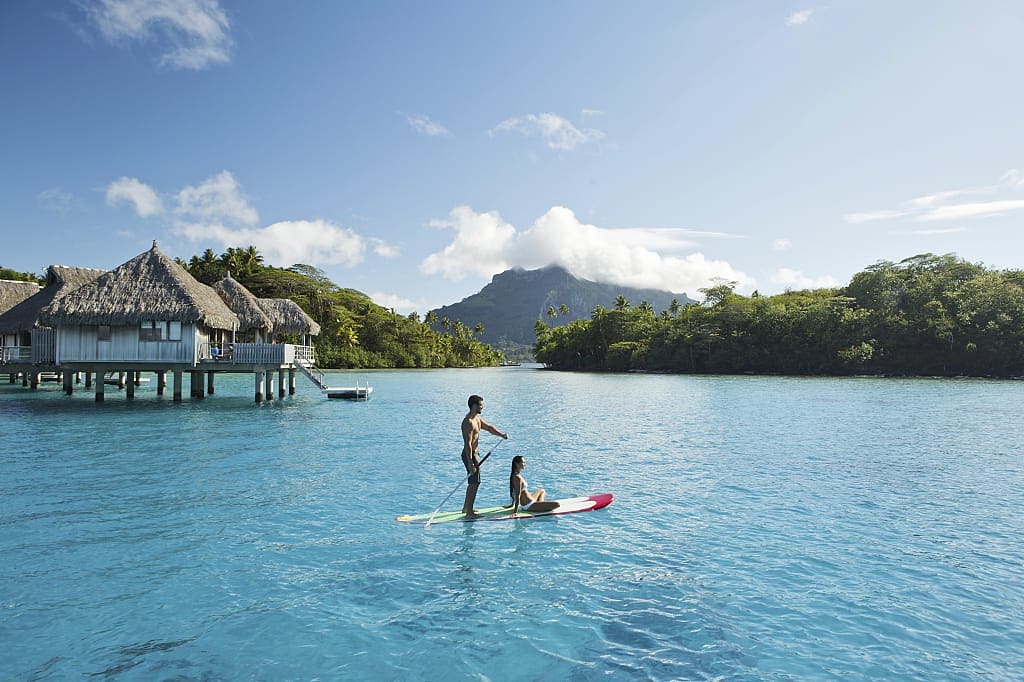 Couple standup paddle boarding in Bora Bora.  Photo courtesy Tahiti Tourisme