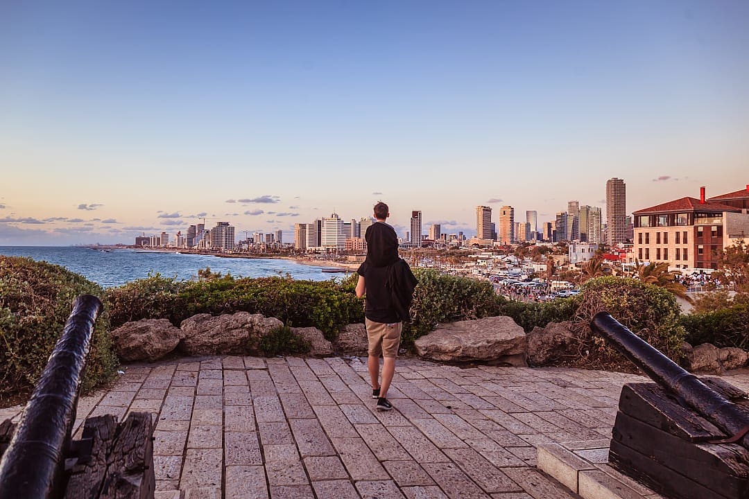 Family walking in Tel-Aviv at sunset Israel