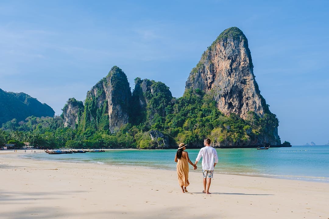 Couple walking along Railay Beach in Krabi, Thailand