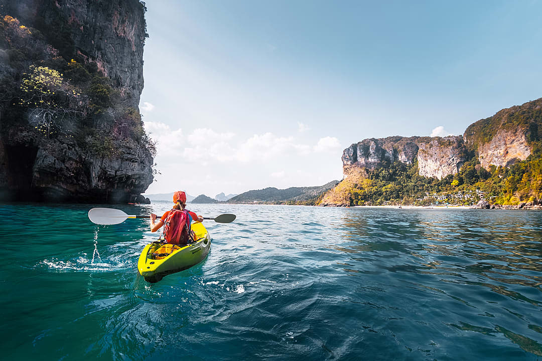 Woman kayaking the Andaman coast in Krabi Province, Thailand