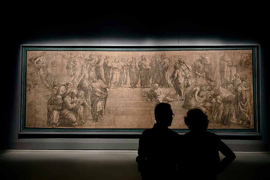 A couple enjoys art together in a museum in Italy.