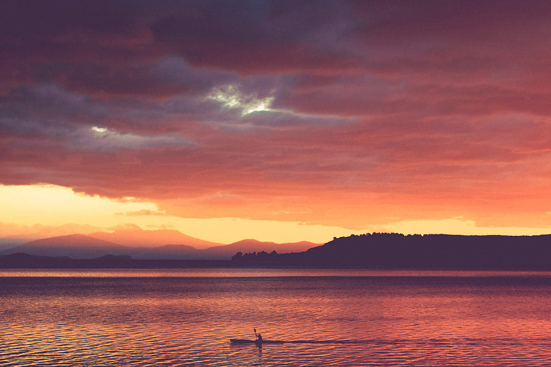 A person kayaking on Lake Taupo, New Zealand.