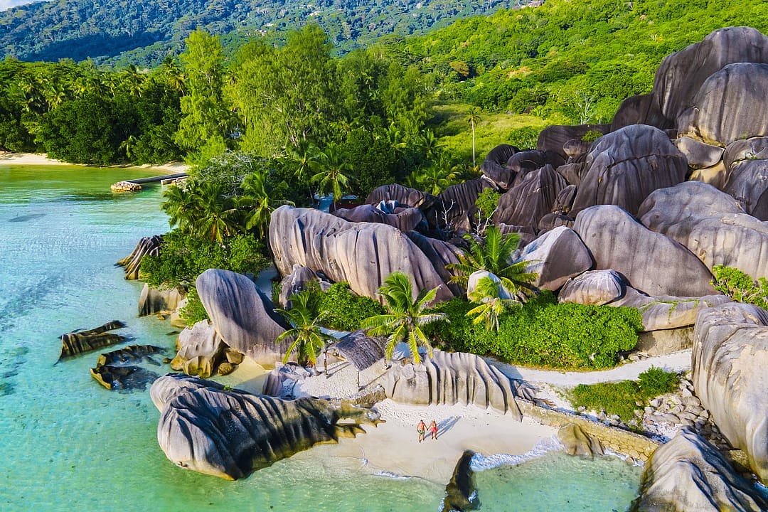 Couple walking in La Digue Island, Seychelles.